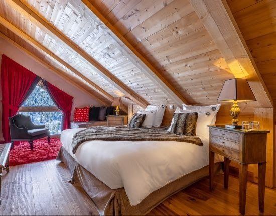 Une chambre mansardée sous les poutres : L'Hélios à Méribel.