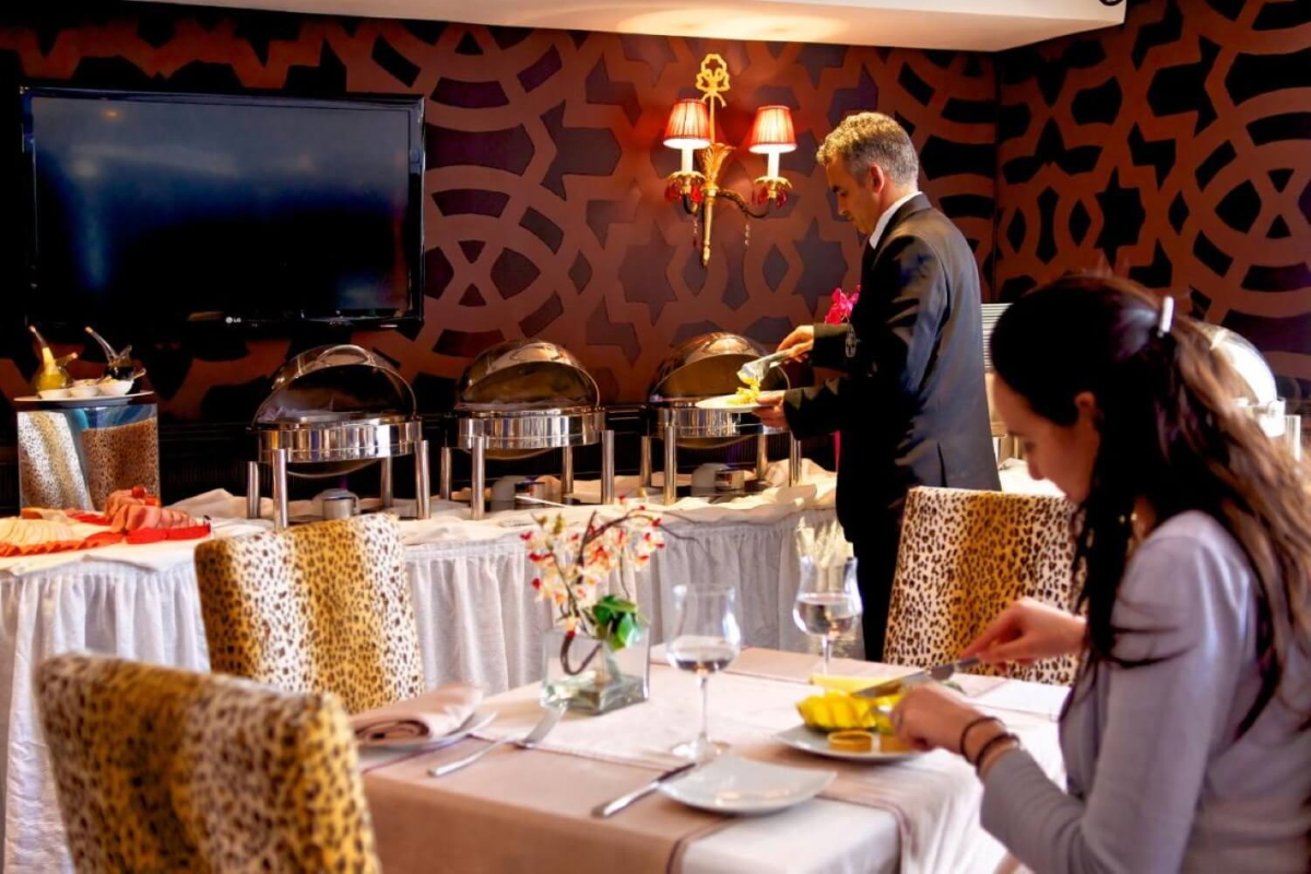 Buffet et table dressée dans la salle du petit déjeuner à l'Art Palace Suites & Spa de Casablanca.