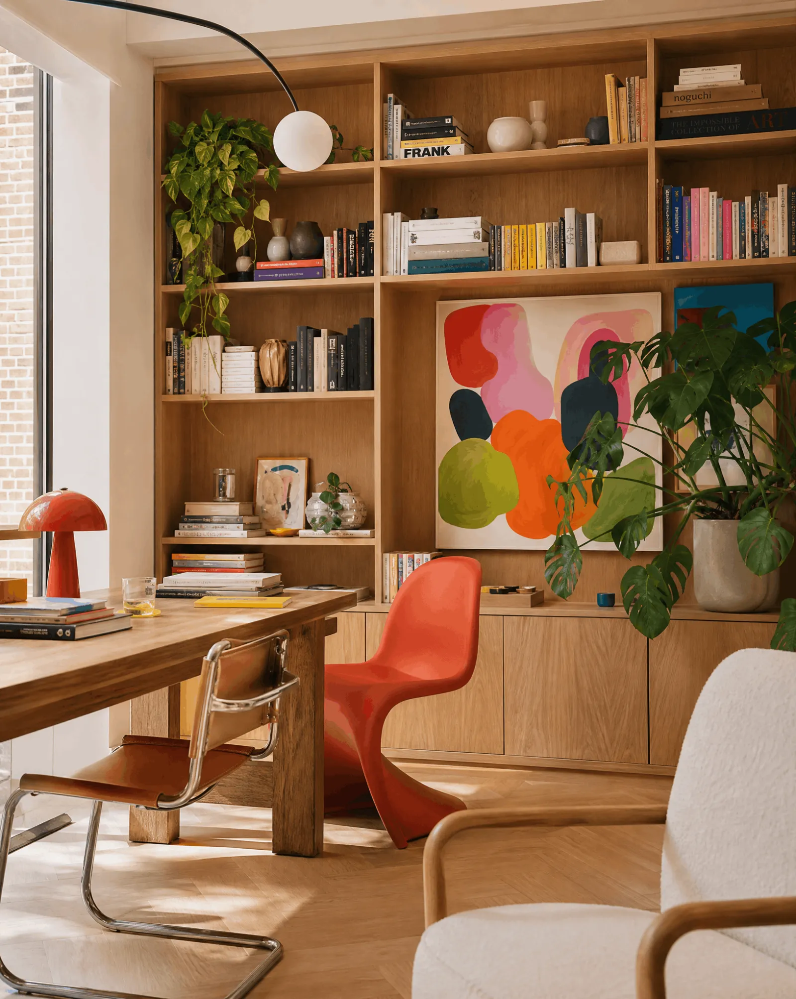 A person relaxing in a chair in a warmly lit home study