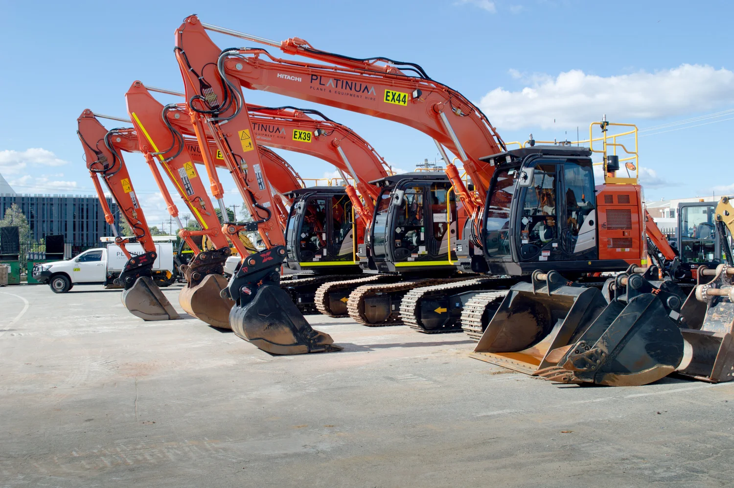 Platinum Hitachi excavators lined up in the yard