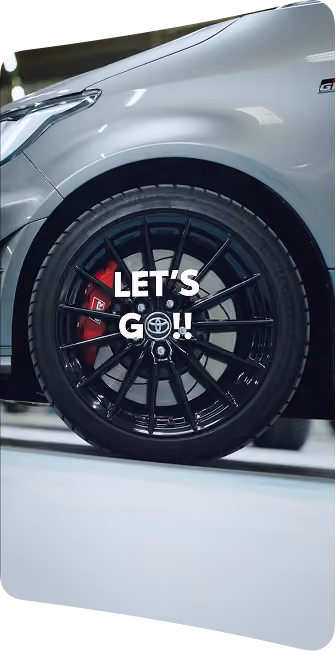 blue2purple - Close-up of a silver Toyota with a black alloy wheel and the caption Lets Go