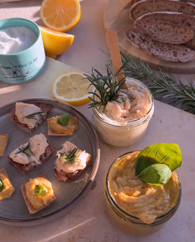 blue2purple - Rye canapes topped with cream and rosemary beside jars of dip and a lemon