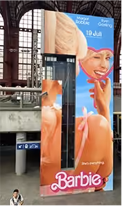 blue2purple - Barbie posters wrapped around lift walls in Antwerp station