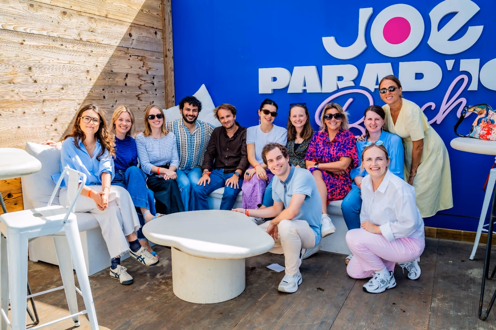 blue2purple - Group of creators posing together in front of a blue Joe Parade wall