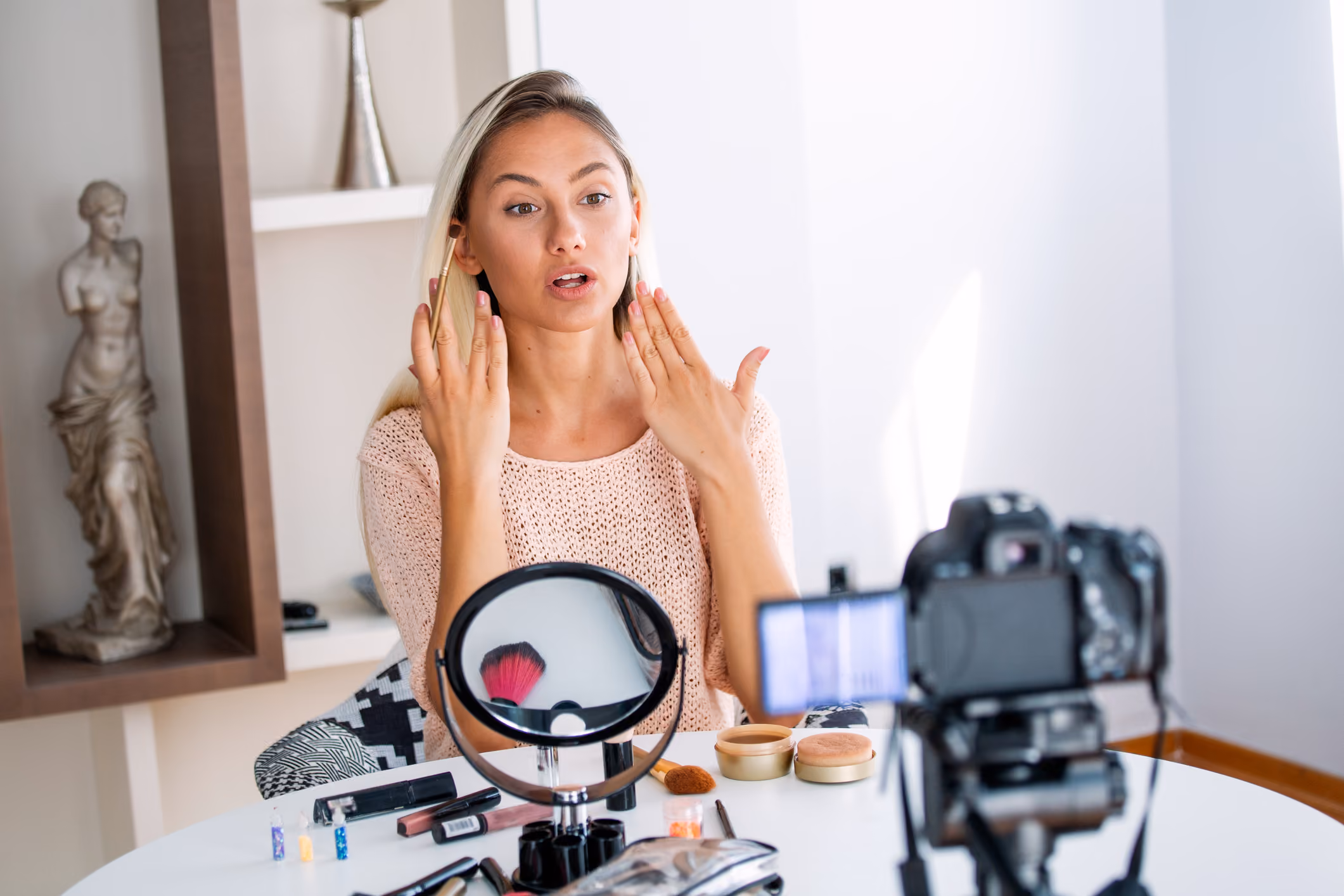 blue2purple - Woman filming a makeup tutorial with a camera and ring light