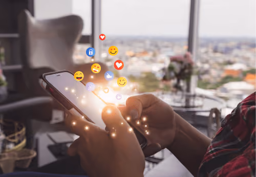 blue2purple - Hands holding a phone with emoji reactions floating above it