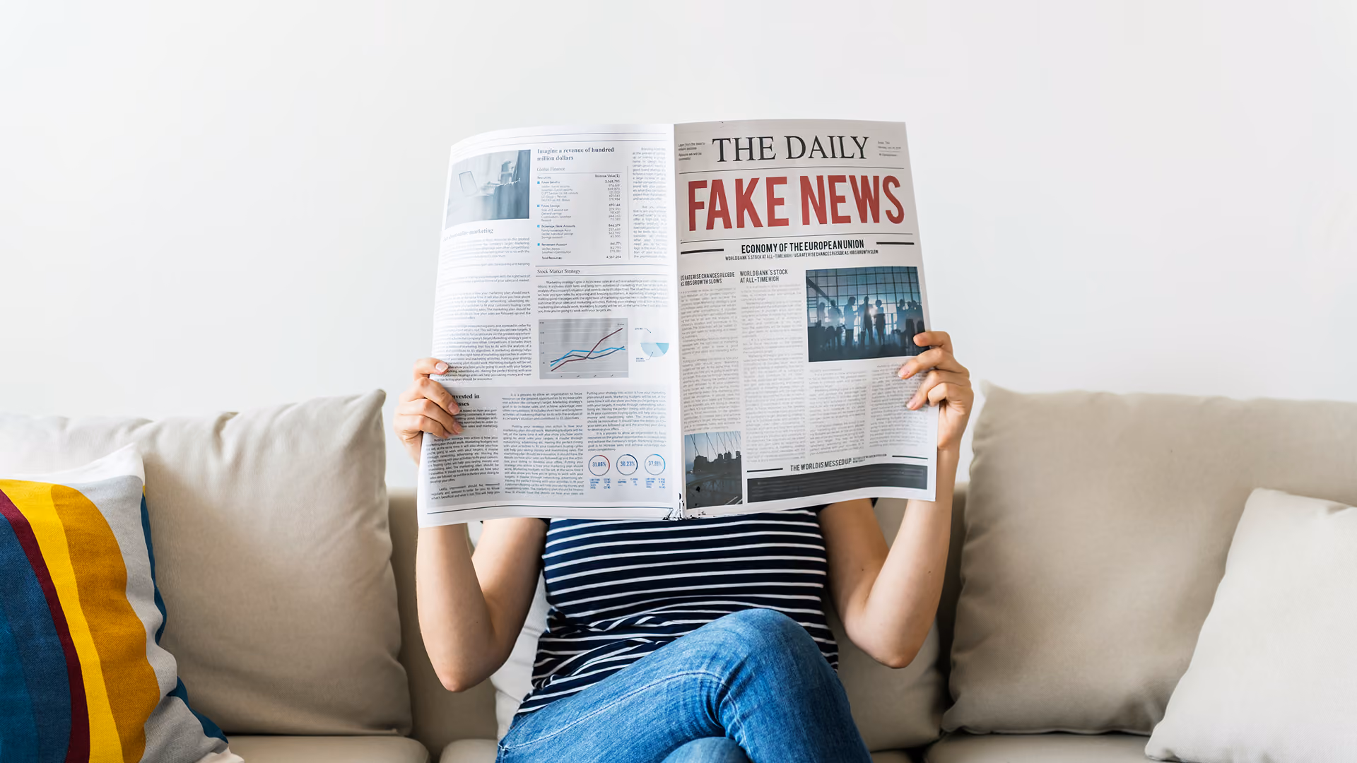 blue2purple - Person on a sofa reading a newspaper with the headline Fake News