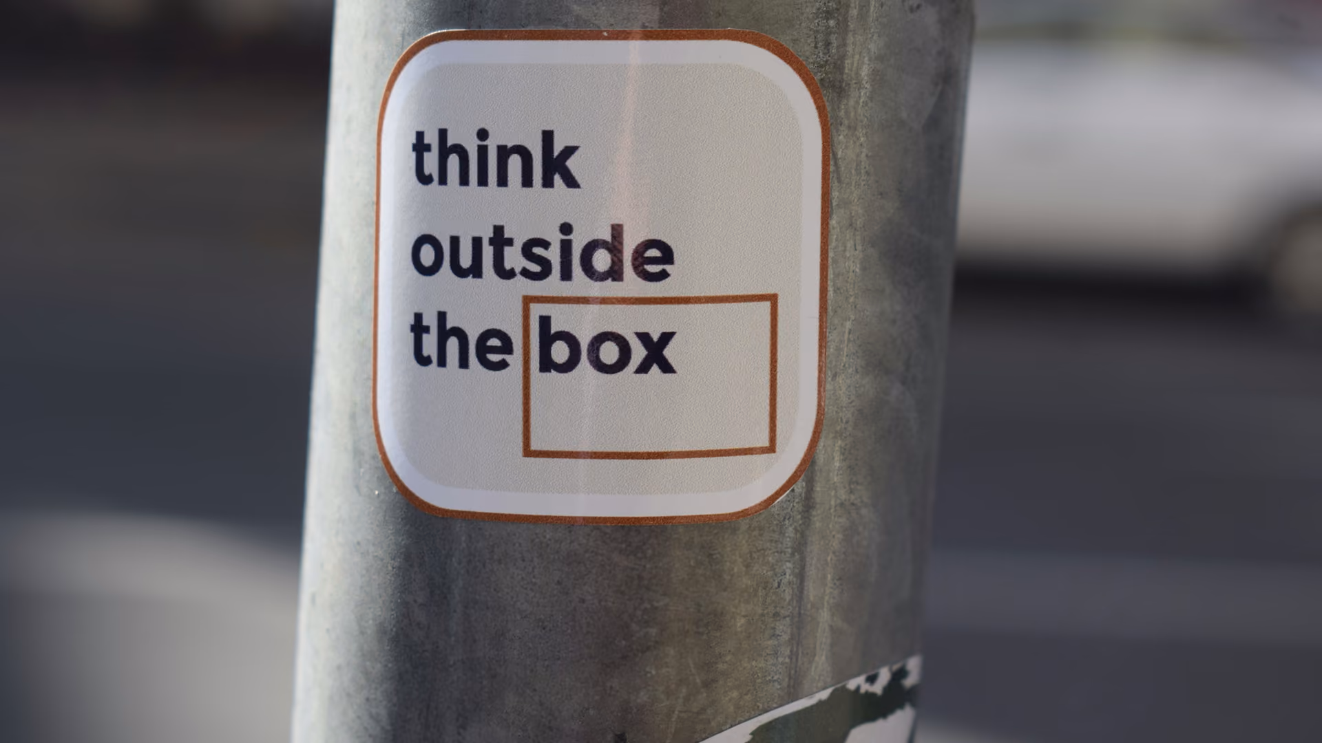 blue2purple - Sticker on a pole reading think outside the box