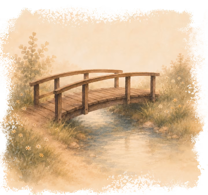 Wooden arched bridge over a calm stream surrounded by soft plants and flowers in a misty setting.