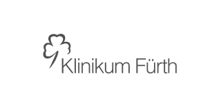 Logo of Klinikum Fürth featuring a stylized clover leaf and text.