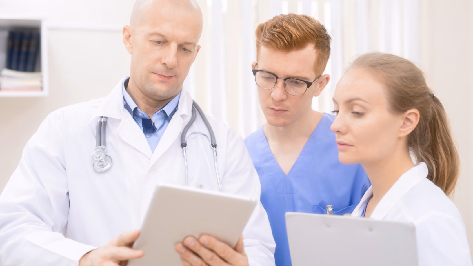 Healthcare provider gently holding an older patient's hands in a supportive gesture.