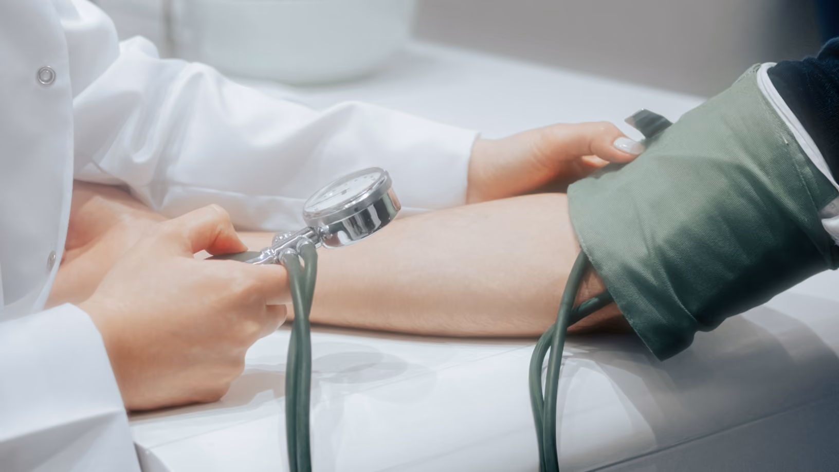 Healthcare provider gently holding an older patient's hands in a supportive gesture.
