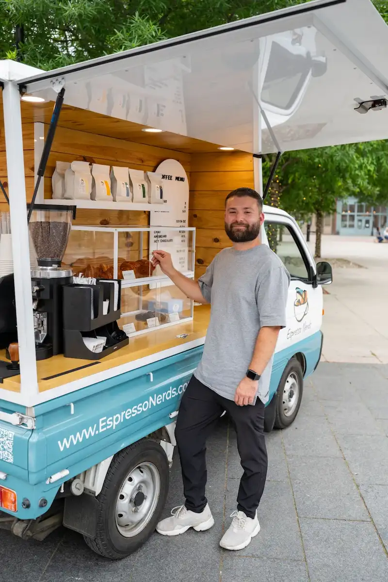 Espresso Nerds barista beside the mobile espresso truck
