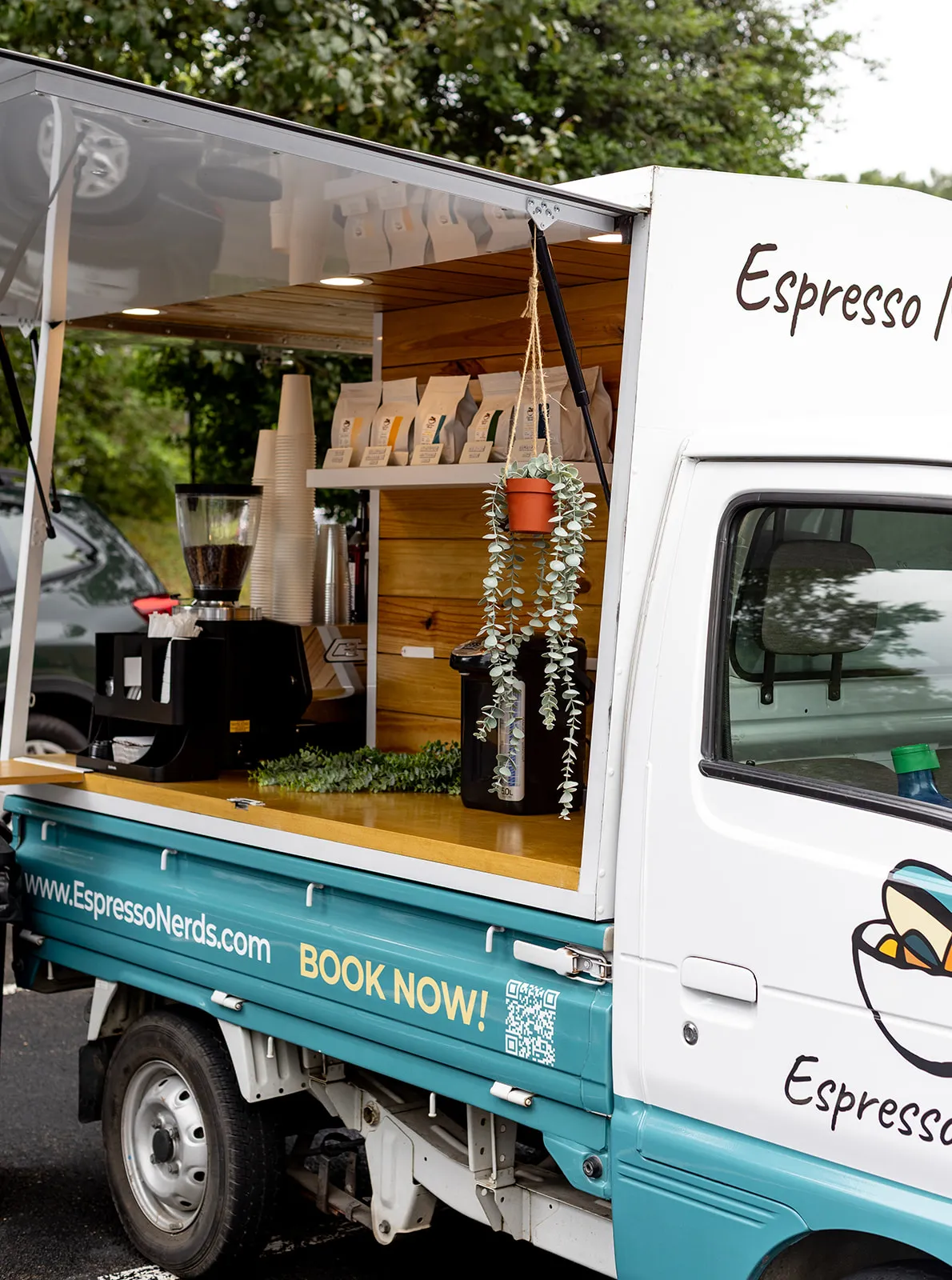 Espresso Nerds Japanese kei truck with the side bar open and espresso machines on the counter