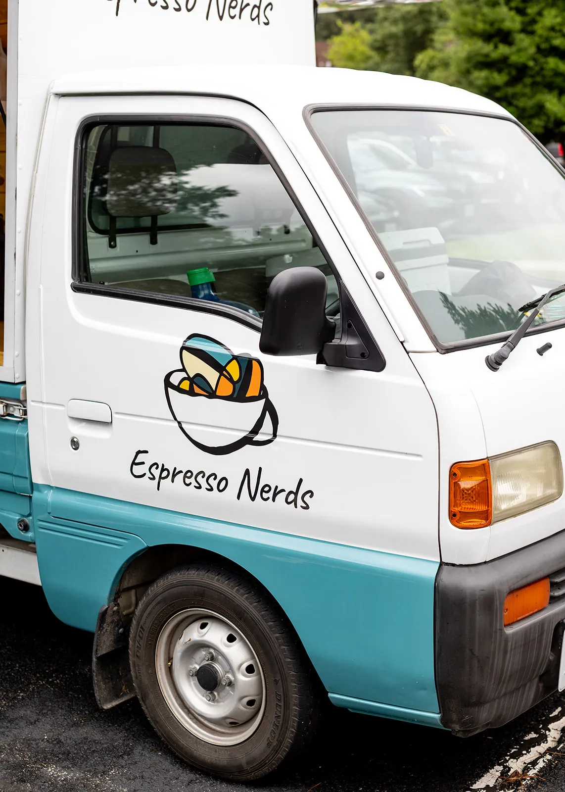 Front view of the white and teal Espresso Nerds kei truck