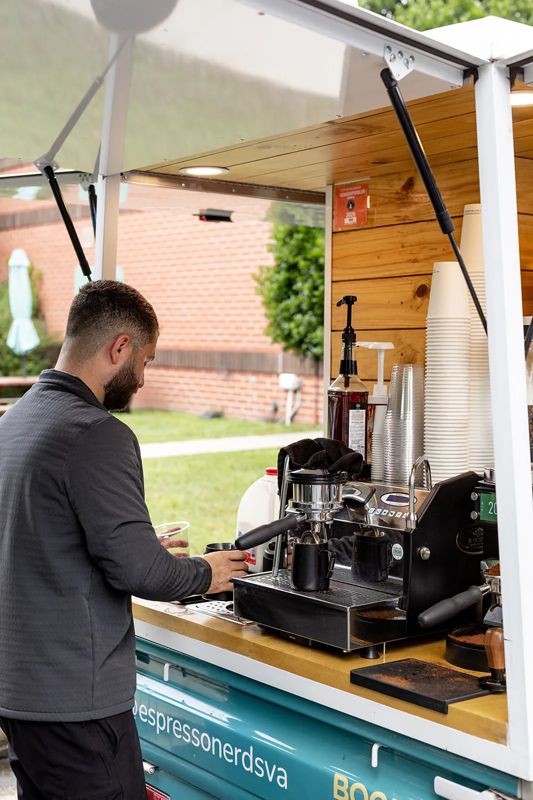 Barista working the espresso machine on the mobile coffee bar