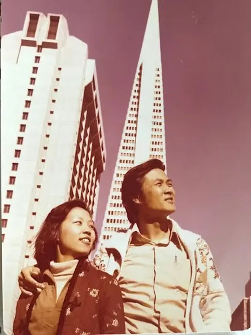 David and Diana Sun standing together in front of the Transamerica Pyramid in San Francisco, 1977