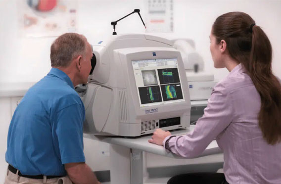 Clinician reviewing retinal scans with a patient