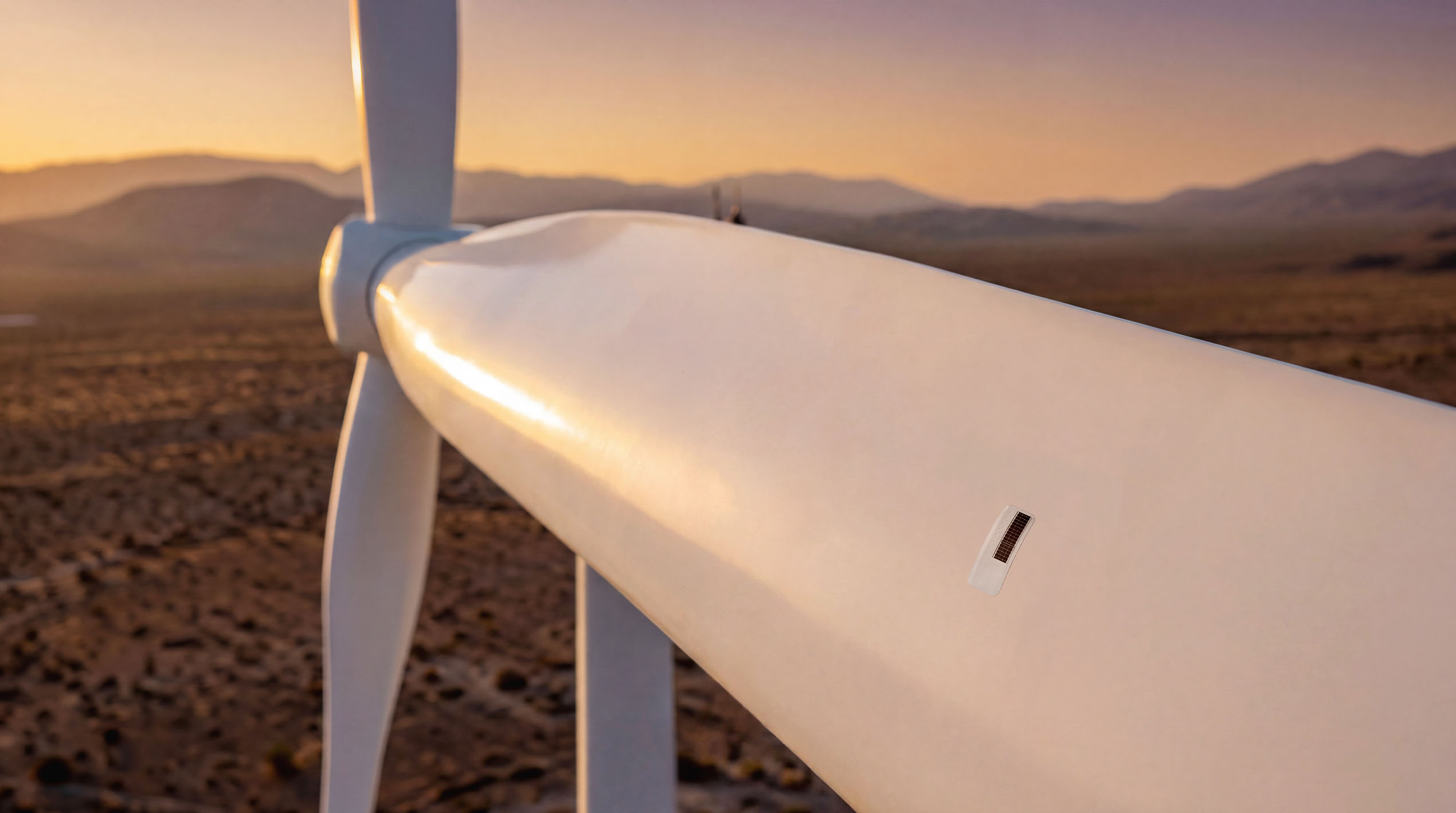 Wind turbine blade at desert sunset with an Aerosense sensor patch