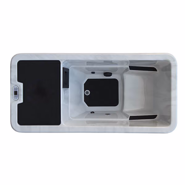 Top view of a white cold plunge tub with black floor pads and built-in control panel on side.