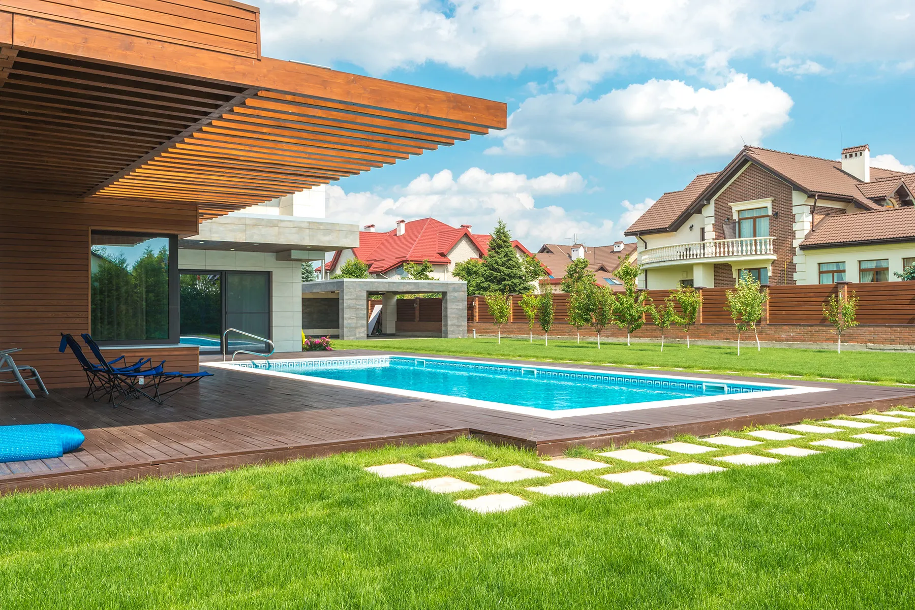 Swimming pool with sunbeds on the territory of a large house