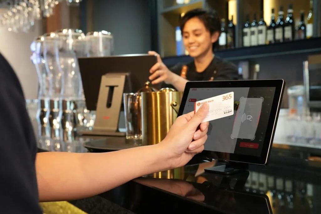 Customer making a contactless payment at a point-of-sale terminal