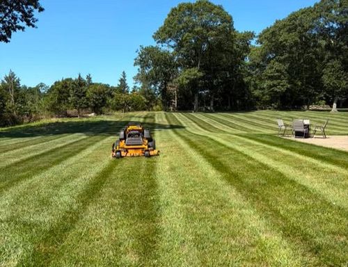 Crisp parallel lawn striping and sharp turf edging on a residential property in Westerly, RI.