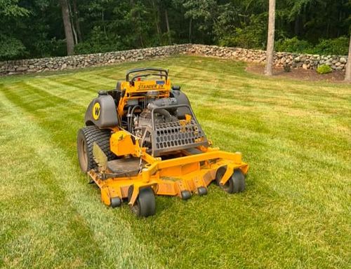 Deep green lawn striping patterns on a large residential estate in coastal Rhode Island.