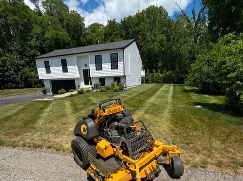 Deep green lawn striping patterns on a large residential estate in coastal Rhode Island.