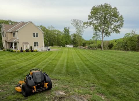 Deep green lawn striping patterns on a large residential estate in coastal Rhode Island.