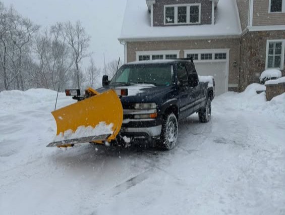 Residential snow plowing and driveway clearing service during a winter storm in Westerly, RI.