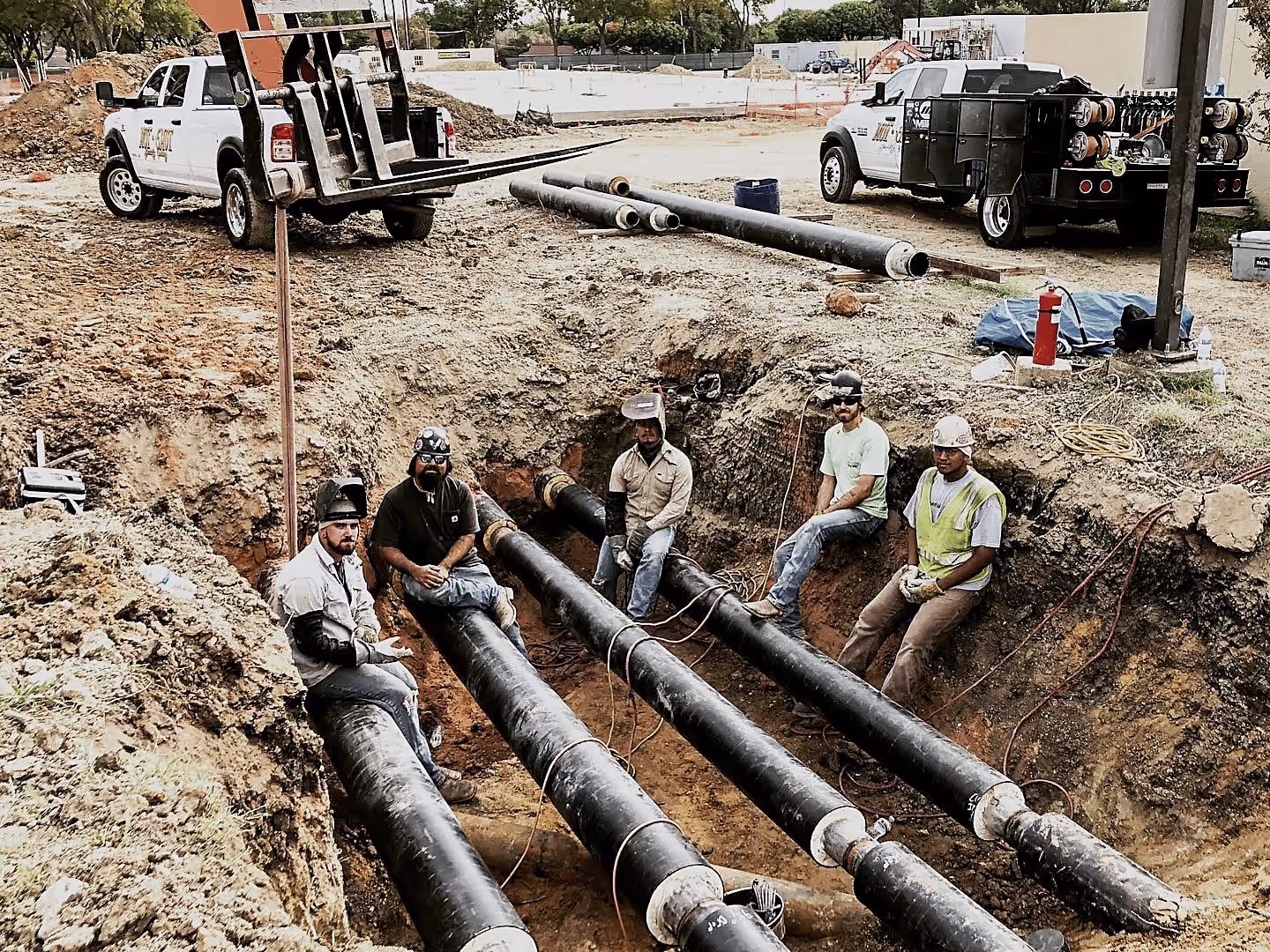 Hot Shot crew welding mechanical piping runs in an excavated trench