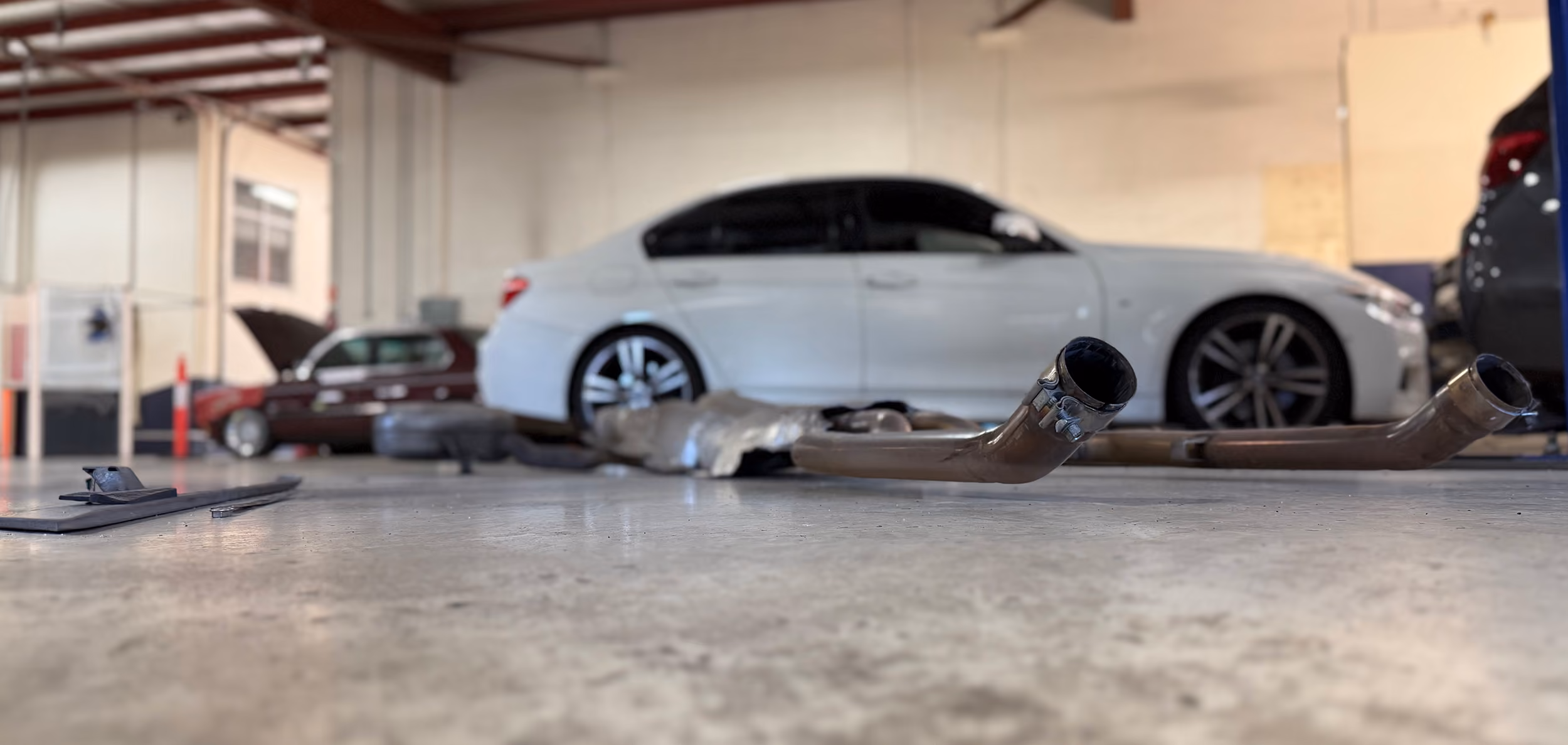 Cars lined up in Auto Tech Group workshop for inspection and repairs.