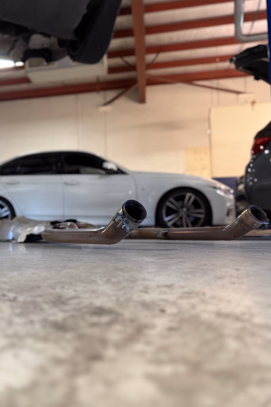 Cars lined up in Auto Tech Group workshop for inspection and repairs.