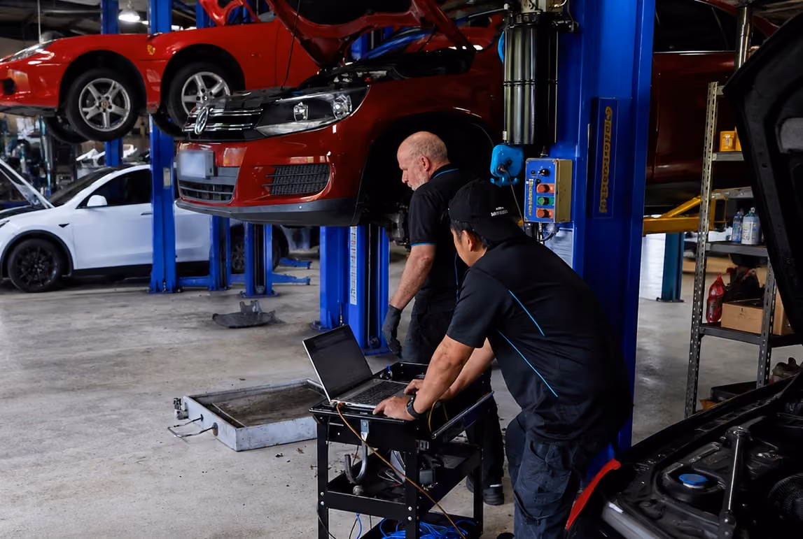 Professional BM Tech specialists performing car maintenance