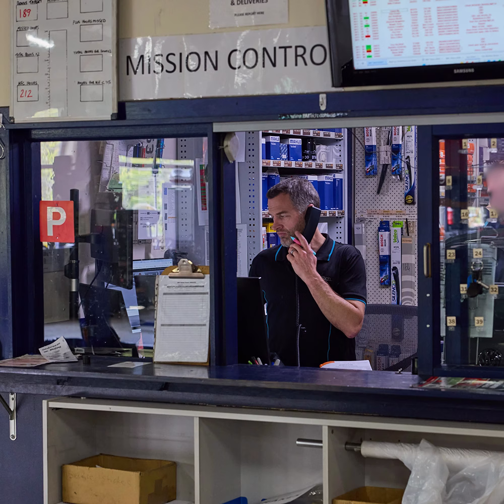 BMT staff member on the phone at the Mission Control service desk