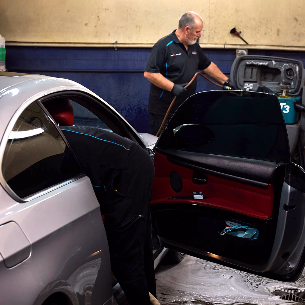 BMT Technicians detailing a silver car in the BMT Workshop