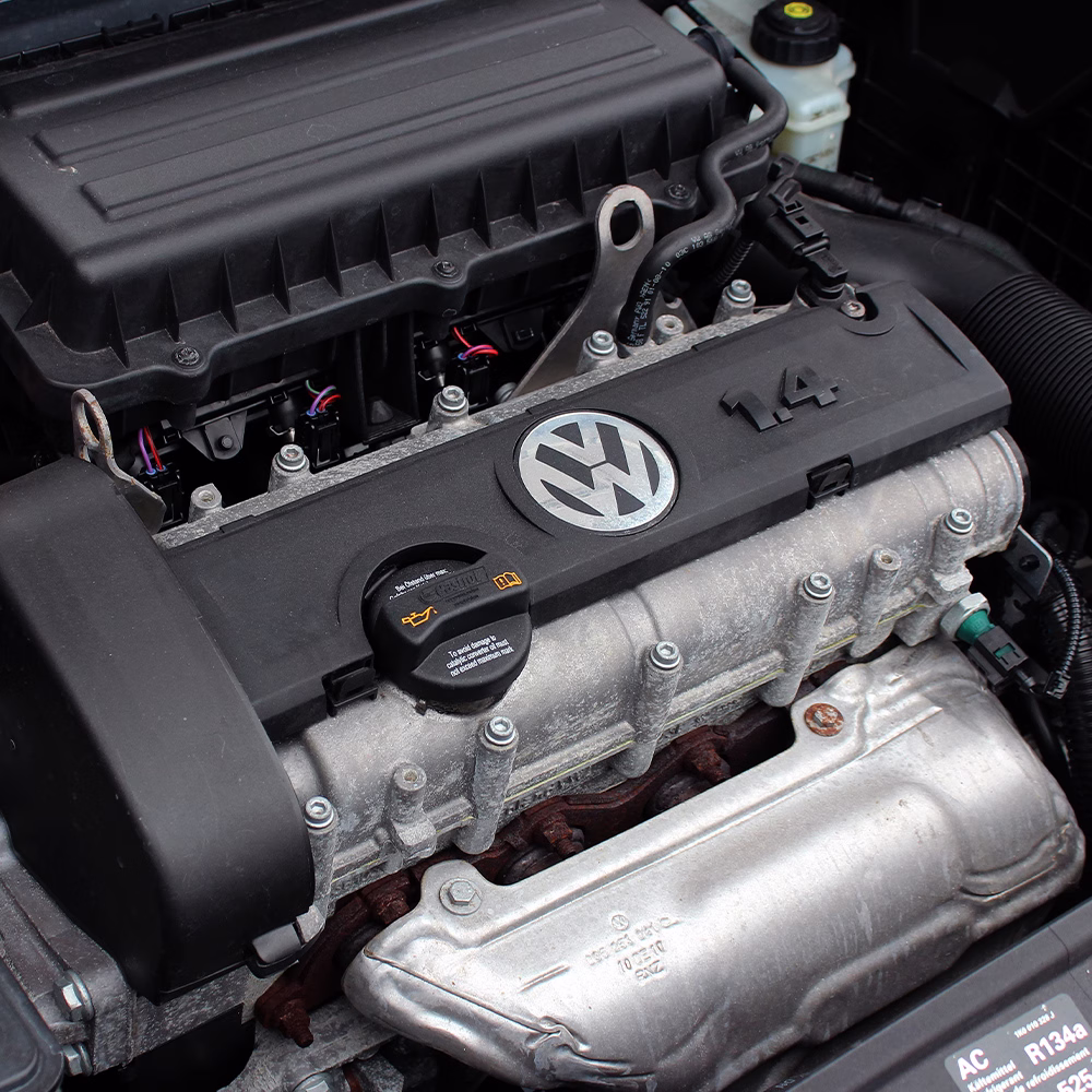 Close-up of a Volkswagen engine bay showing the 1.4-litre engine and surrounding components.