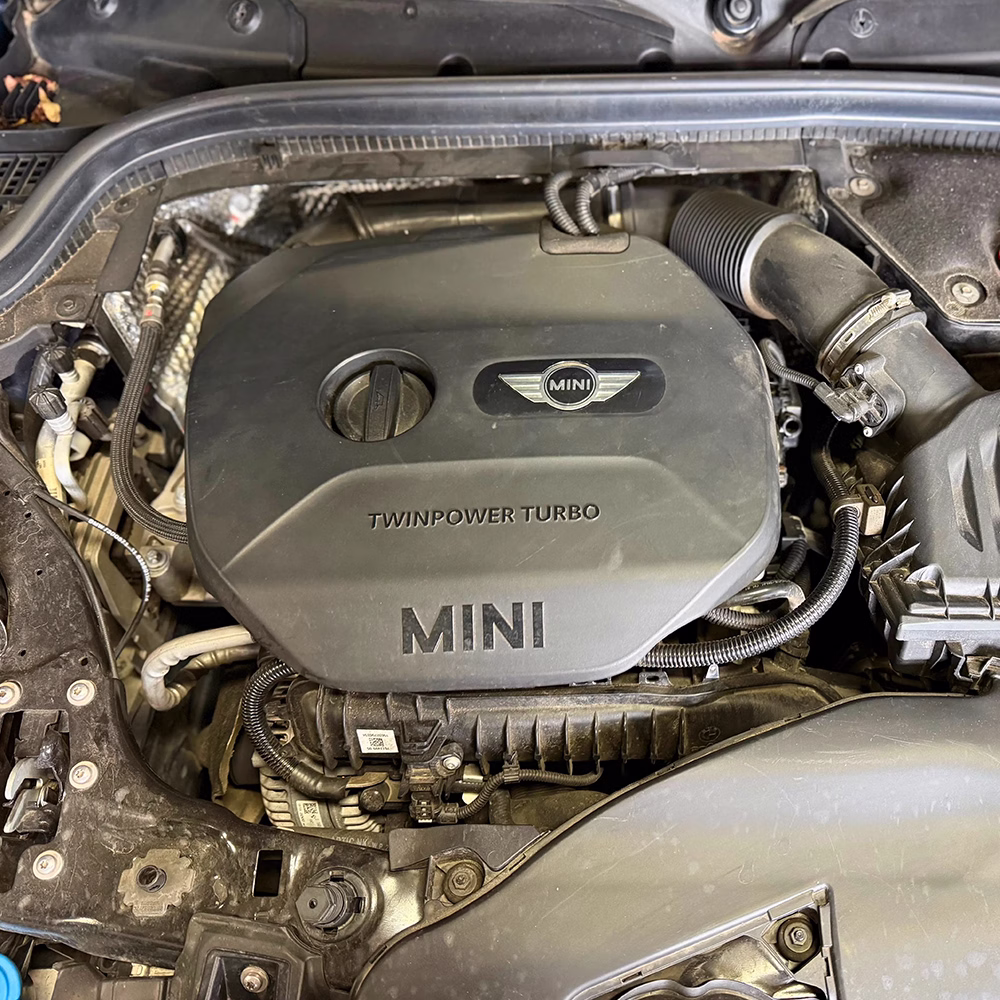 Close-up of a MINI TwinPower Turbo engine and components under the bonnet.