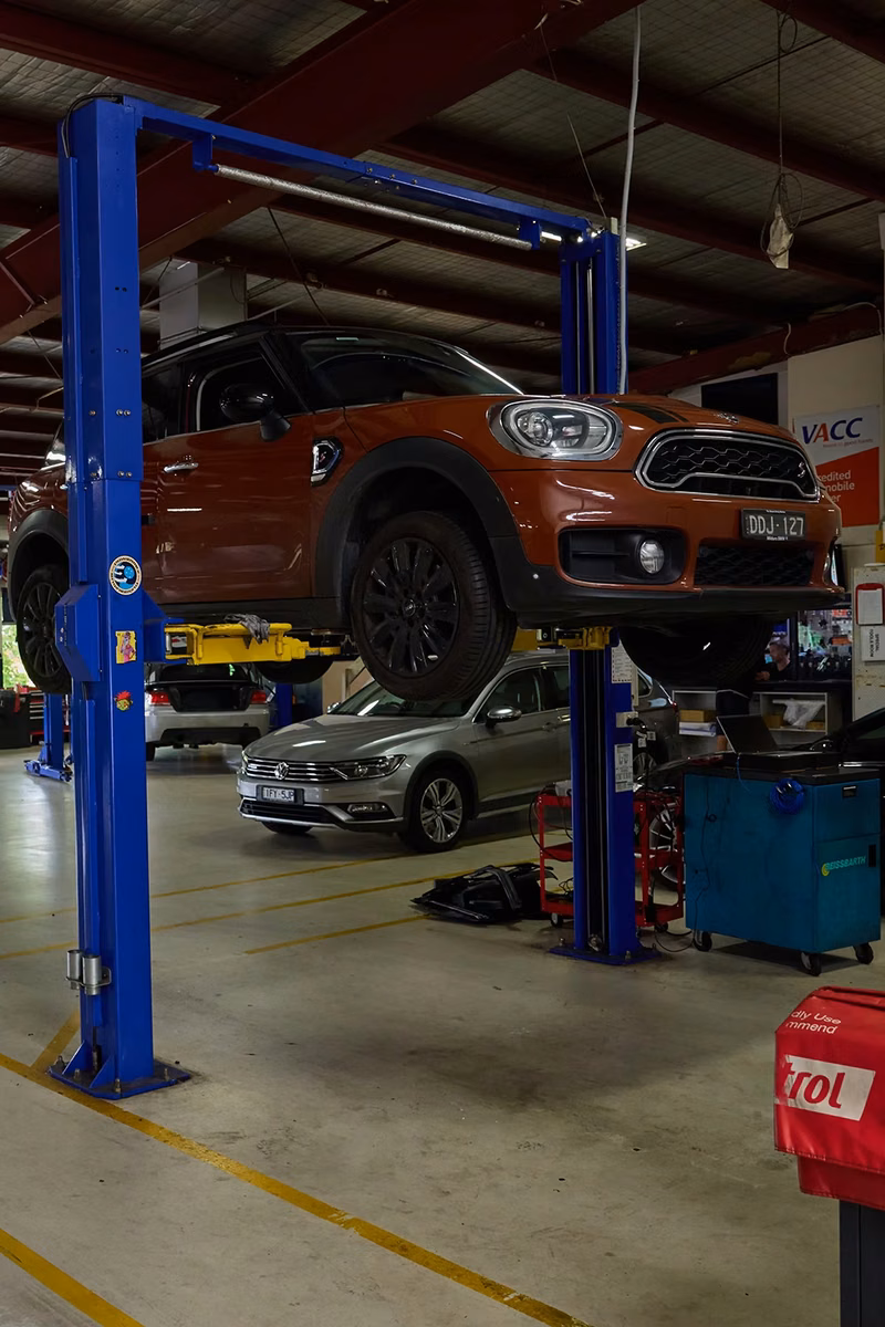Mini on a lift in the BMT Workshop during vehicle repairs