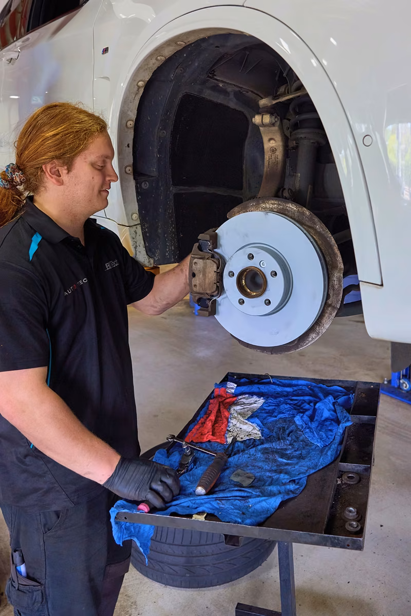 BMT Technician inspecting brake discs on a car in the BMT Workshop