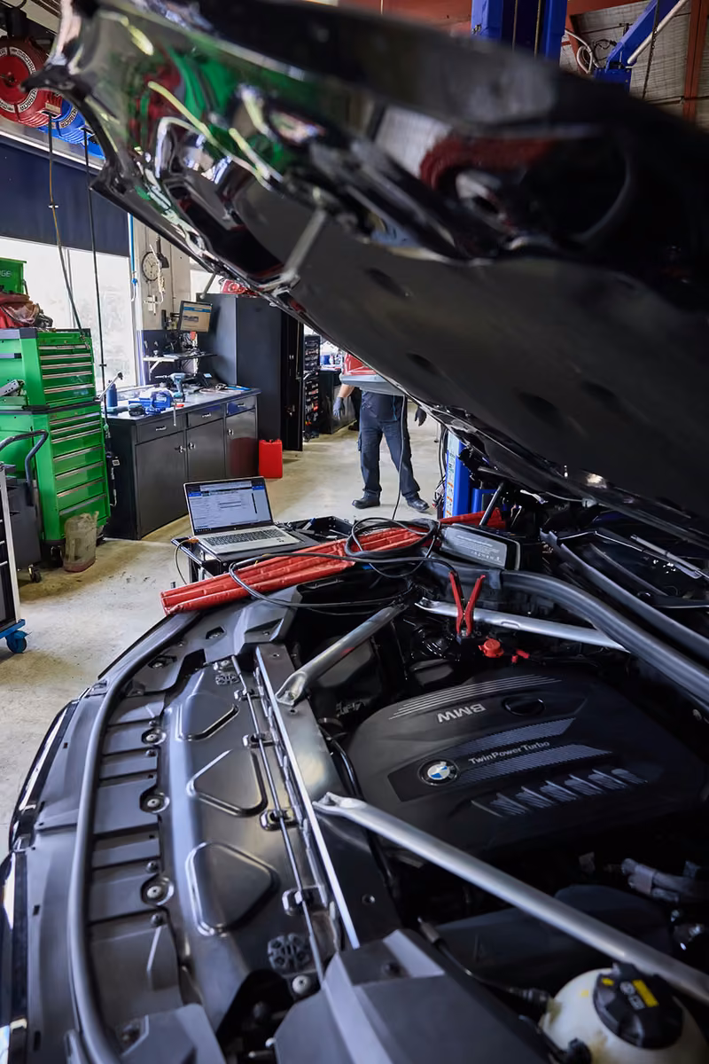 Diagnostic laptop connected to a BMW engine in the BMT Workshop