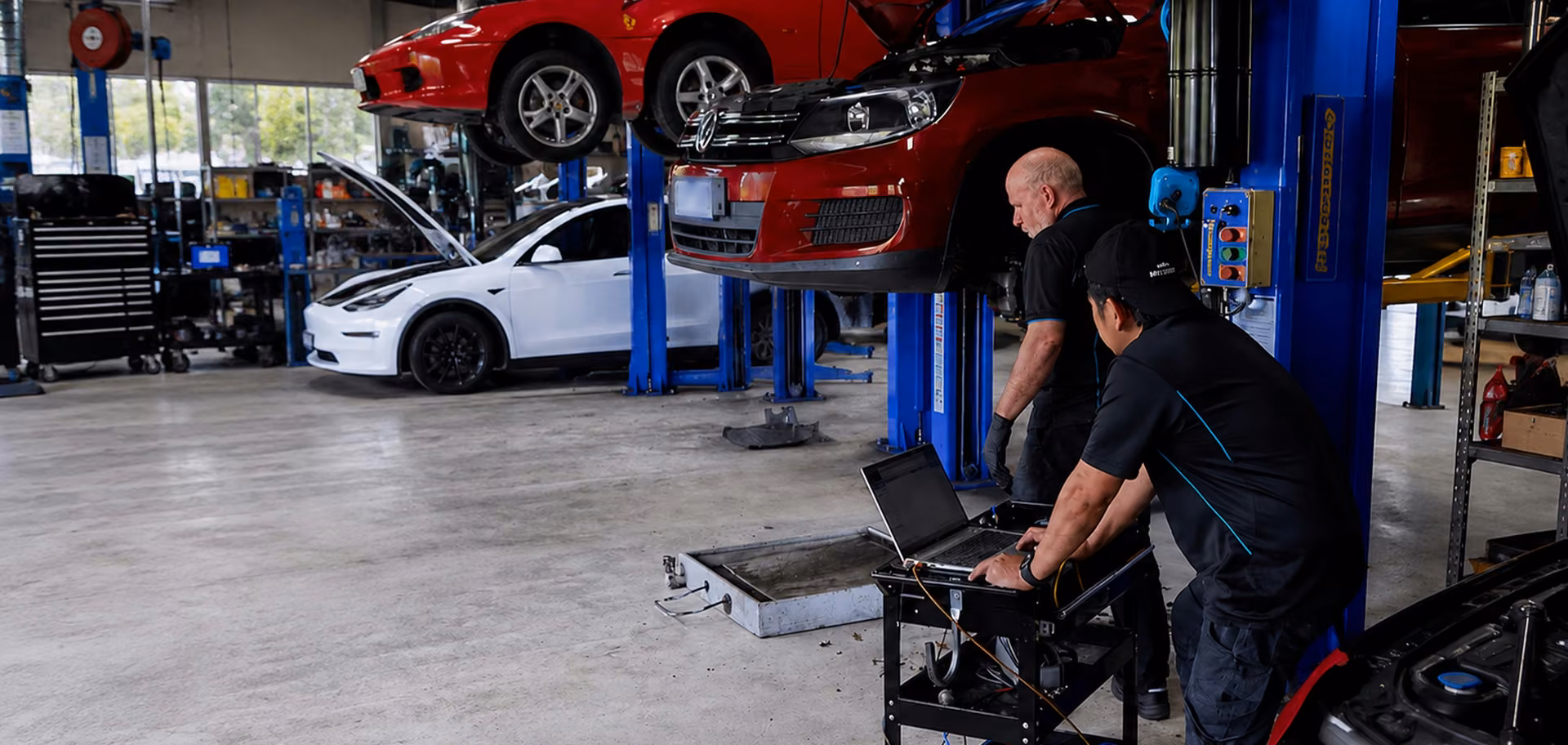 Technician running car diagnostics at the BM Tech workshop