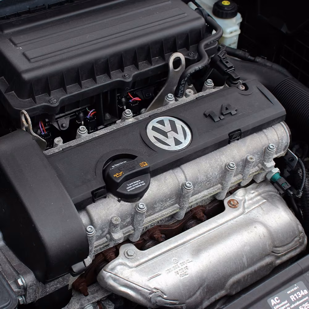 Close-up of a Volkswagen engine bay showing the 1.4-litre engine and surrounding components.