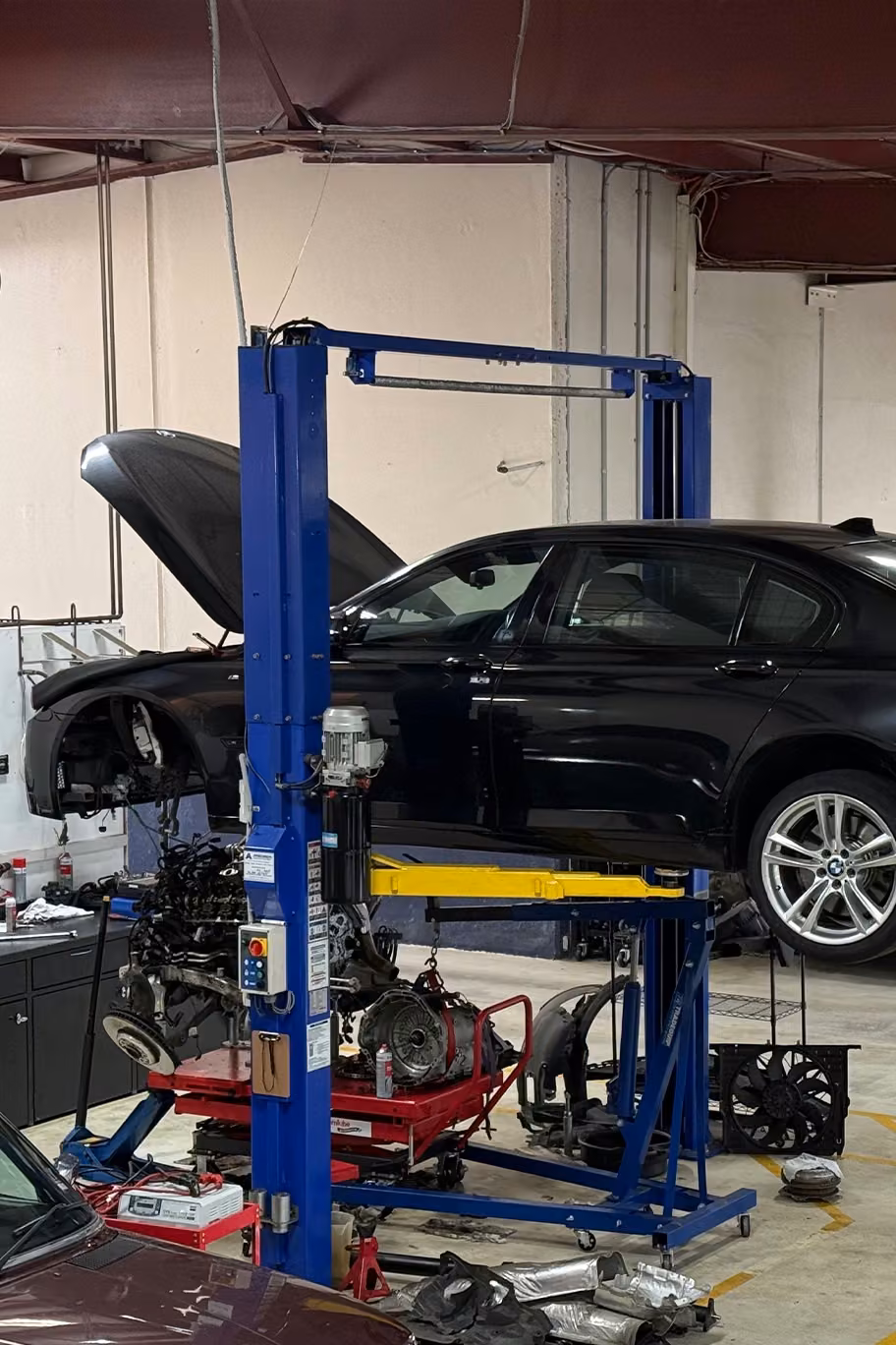 Vehicle inside the workshop being prepared for repair work.