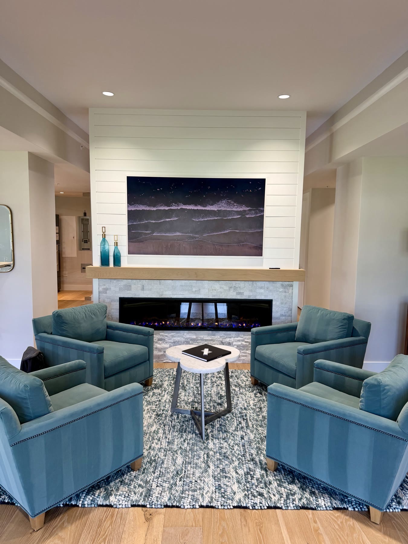 Showroom lounge with an integrated display, fireplace, and layered lighting