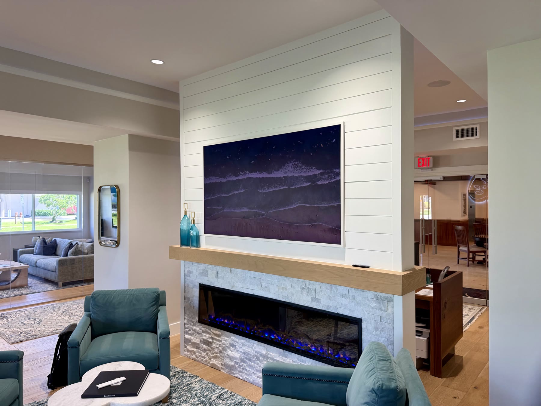 Showroom media wall with a flush-mounted display and illuminated fireplace