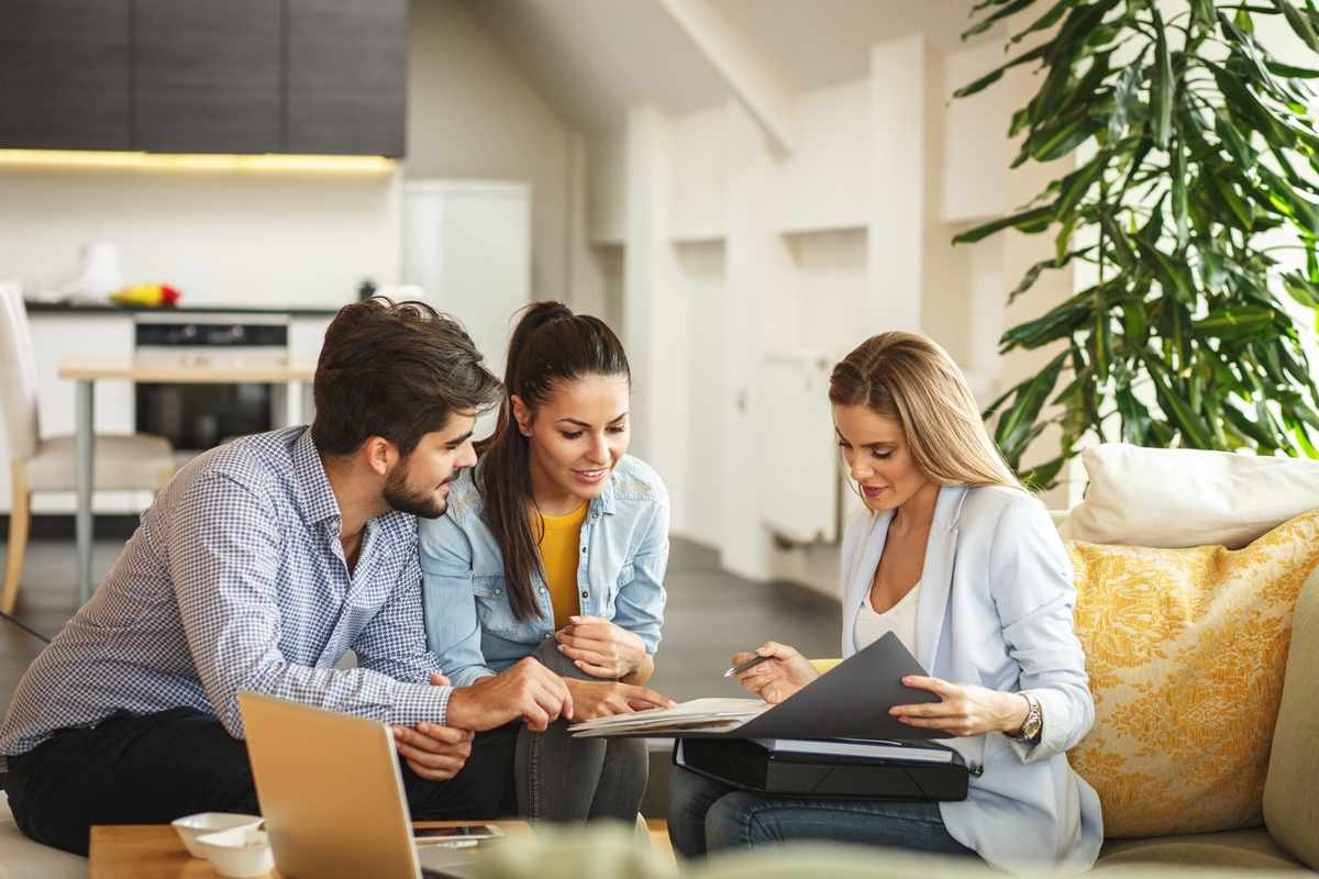 Friends reviewing options together on a laptop