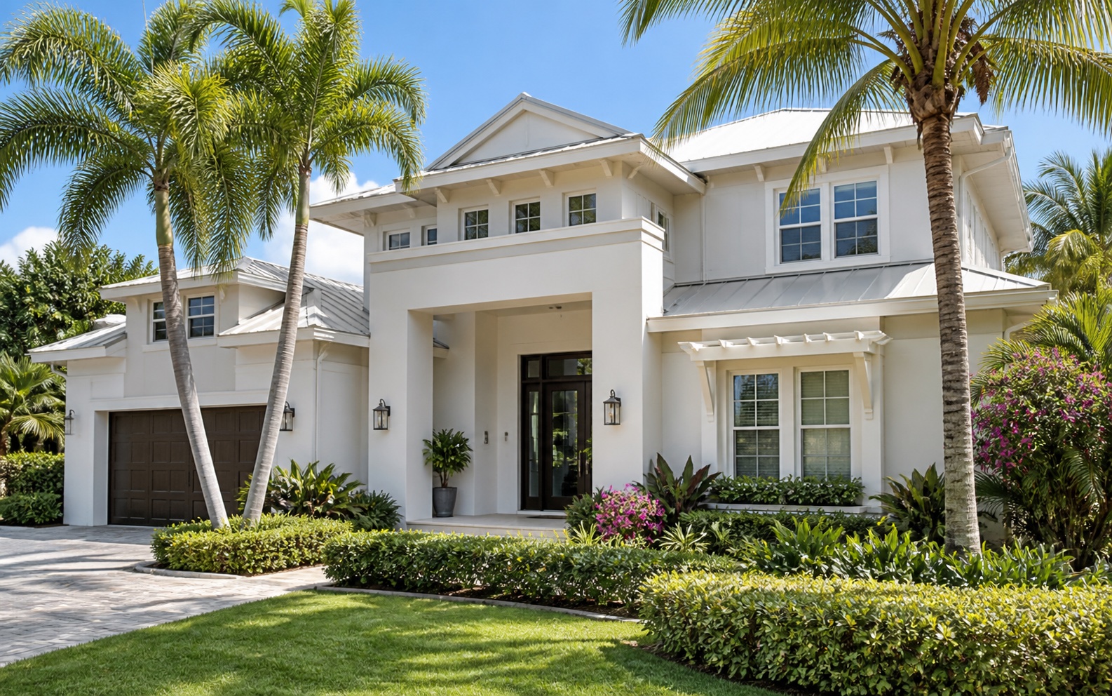 Luxury Southwest Florida residence viewed from the front through tropical landscaping