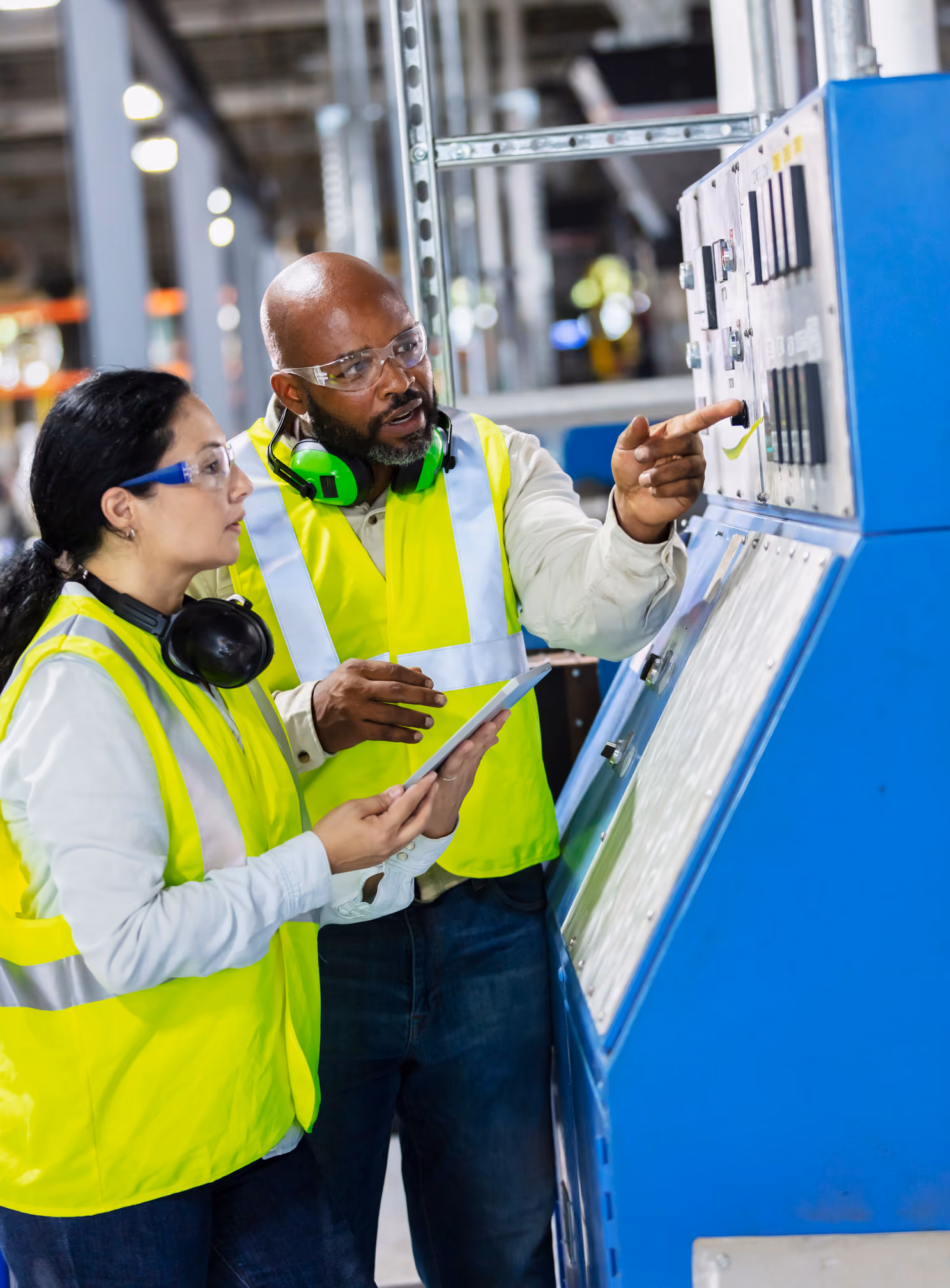 Two workers in conversation in an industrial setting